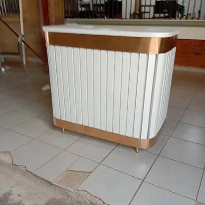 White fluted reception desk with gold trim