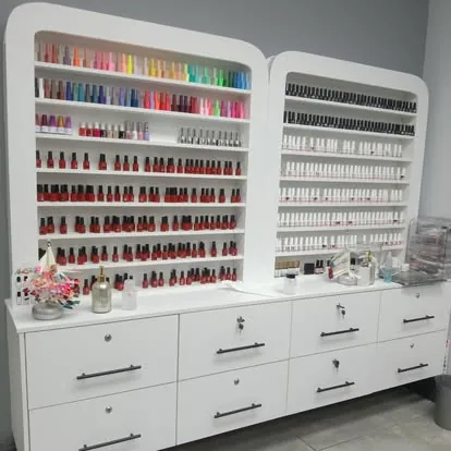 White nail salon polish wall with drawers