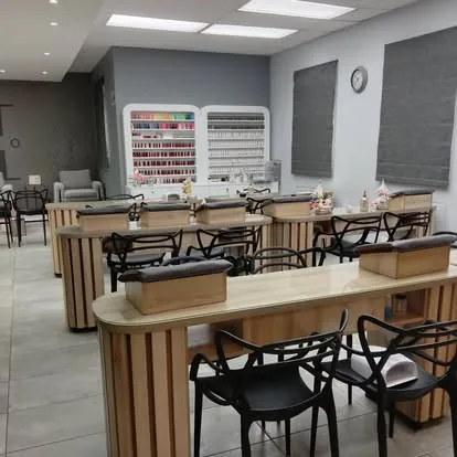 Nail salon with timber tables and polish walls
