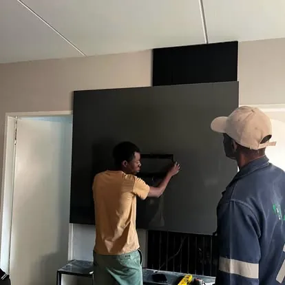 MK team installing a black TV feature wall panel