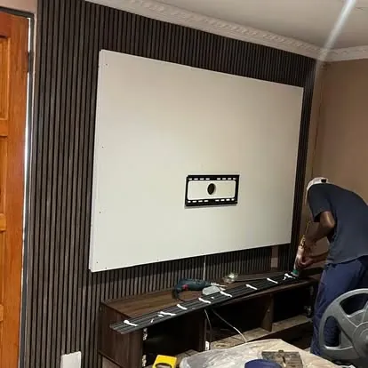 MK installer fitting a TV wall panel